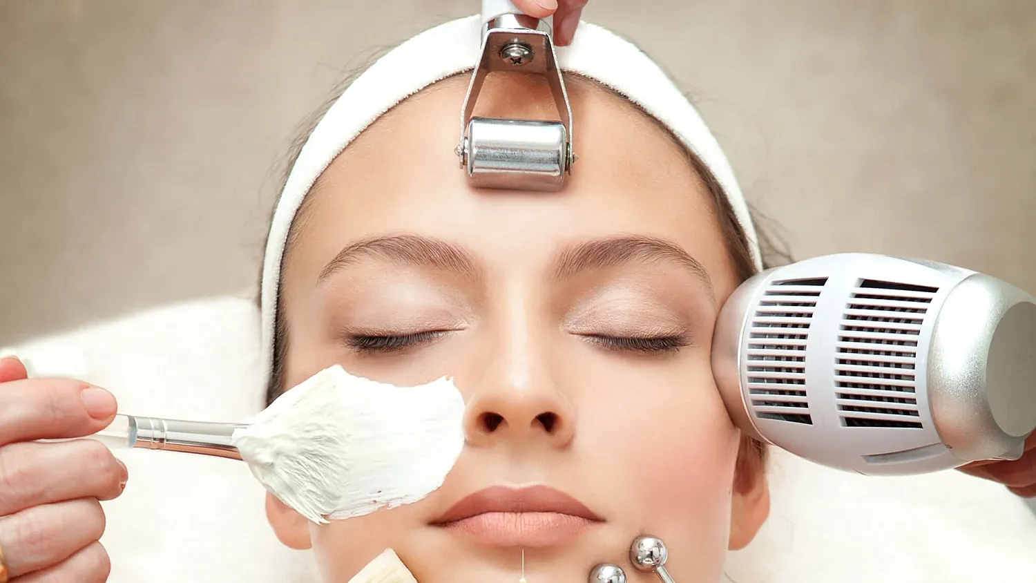 Skincare treatment with various beauty tools.