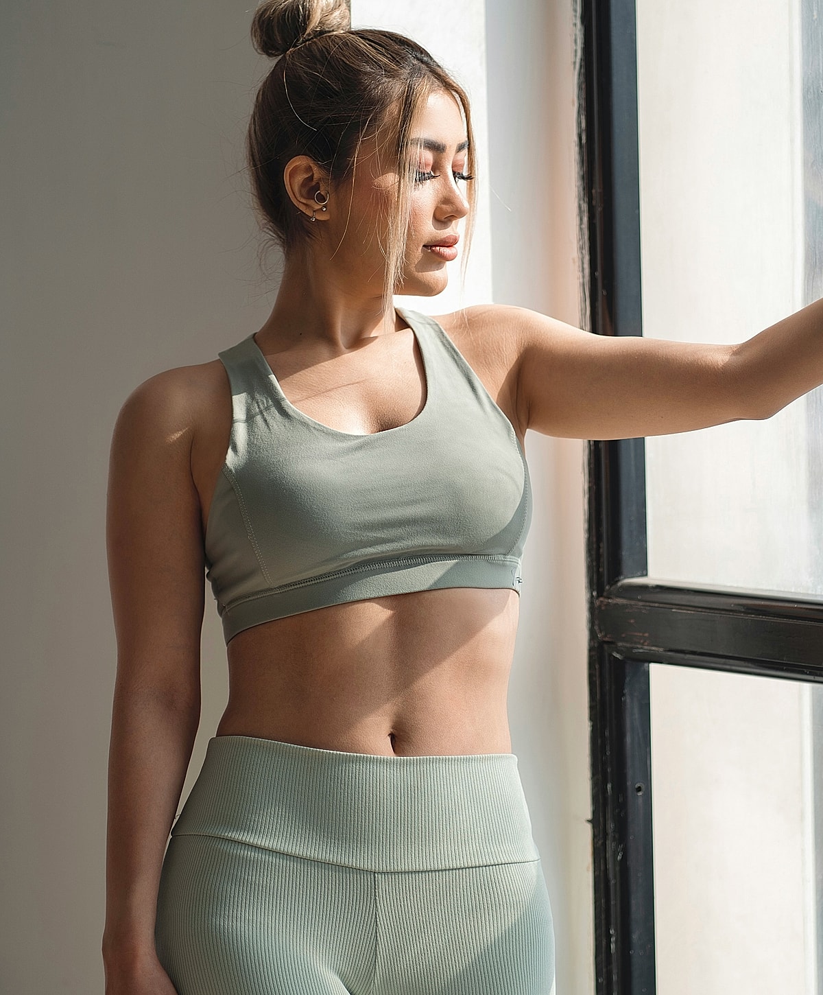 Woman in white top relaxing on a sofa.