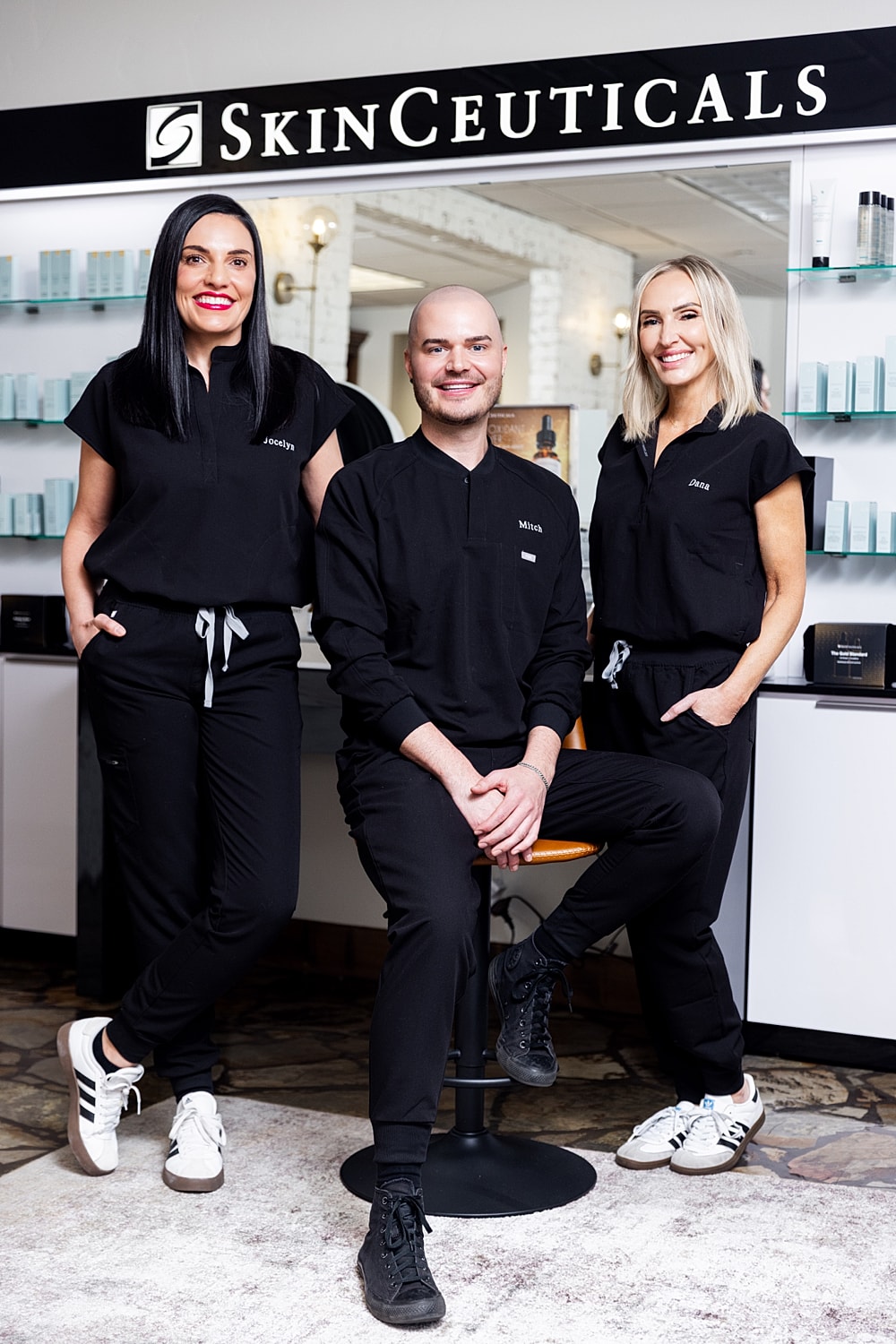 Smiling woman with long, blonde hair outdoors.