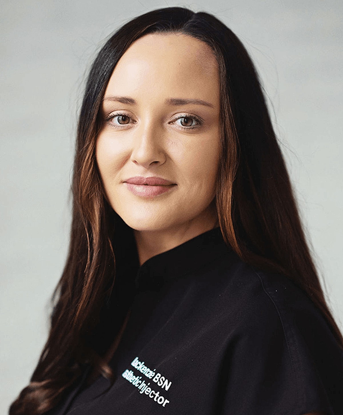 Female healthcare professional with long hair.