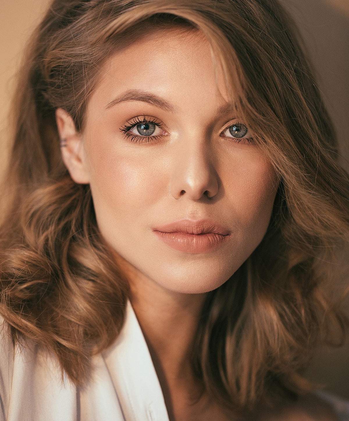 Close-up portrait of a woman with wavy hair.