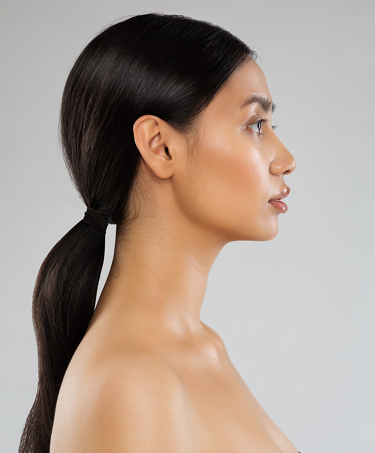 Profile view of a woman with sleek hair.